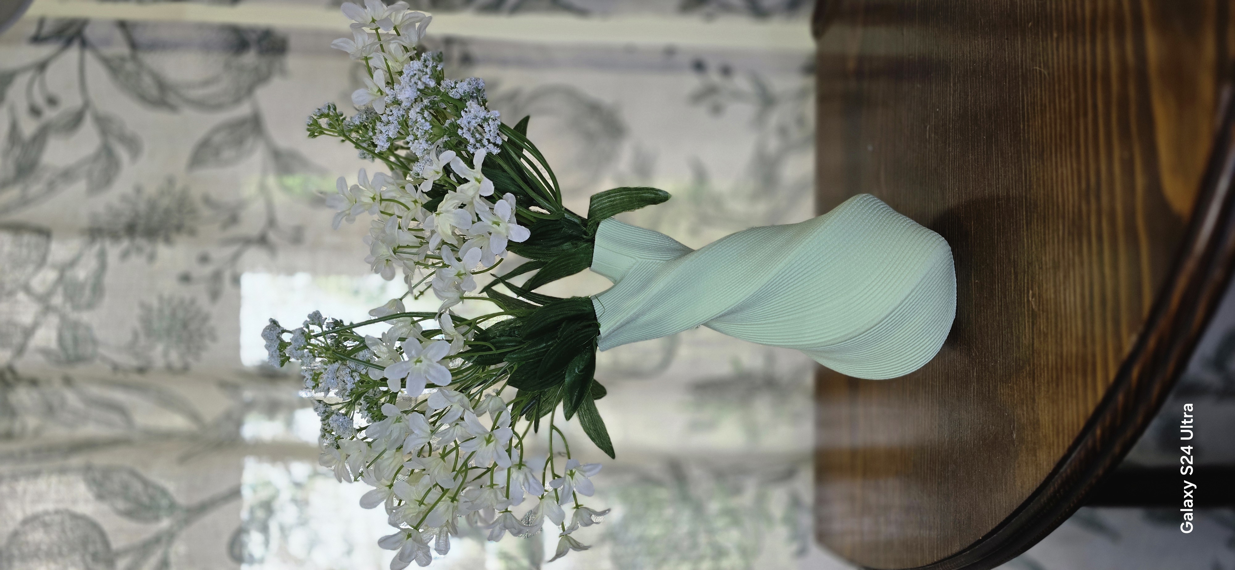 Mint green twisted vase with white wildflowers
